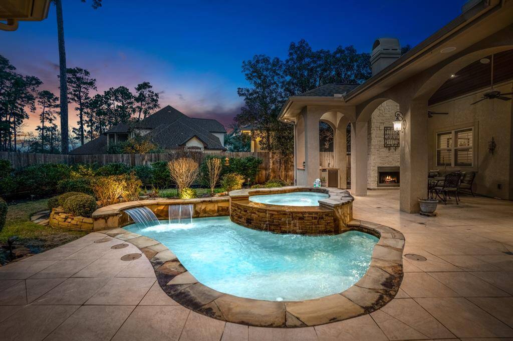 Comfortable seating arrangements under the lanai, overlooking the pool, invite relaxation or entertaining for guests. Designed for both casual lounging and formal dining, this space is versatile for various occasions.
