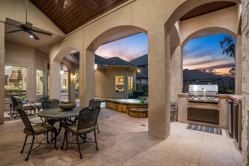 A focused view of the lanai showcases the outdoor kitchen and dining area, emphasizing the space's functionality and comfort. This design encourages outdoor living, rain or shine, making it a versatile extension of the home.