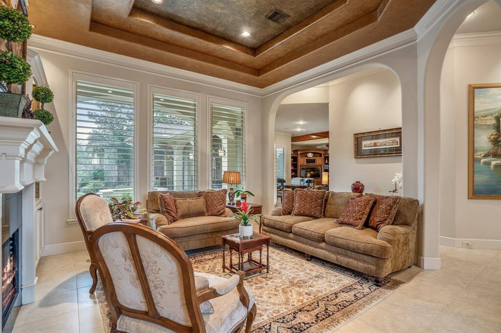 Another angle of the formal sitting room showing the view to the backyard as well as the kitchen, breakfast & living areas.