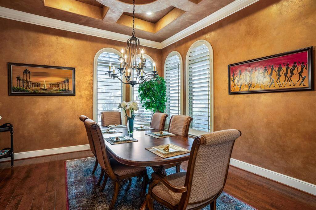 The spectacular attention to detail carries over into the formal dining room, where you will notice a similar custom painted coffered ceiling with unique detail, creating cohesiveness across the two formal entertaining spaces.