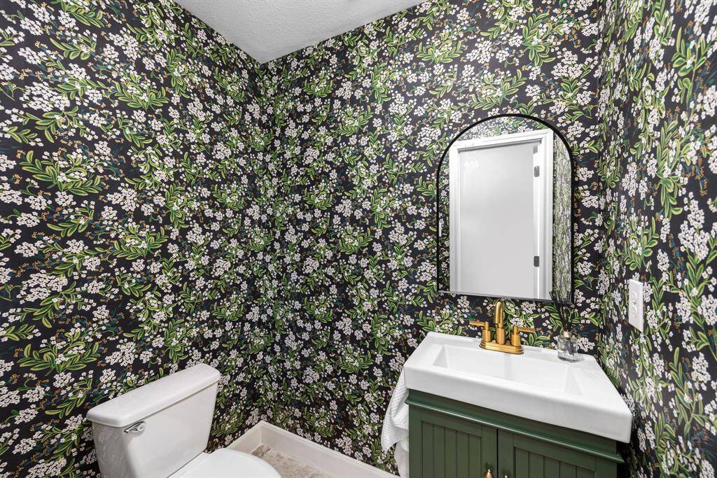 Half bathroom near the back patio entrance.