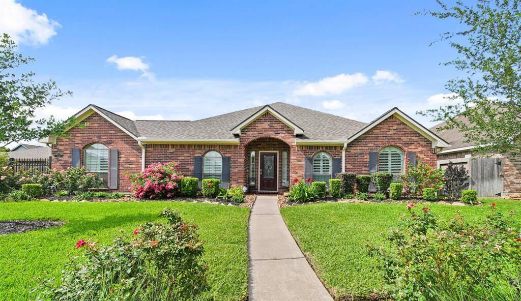 Welcome to your dream home! Over 1/4 acre lot size with brick exterior, lush landscaping, and an inviting entryway.