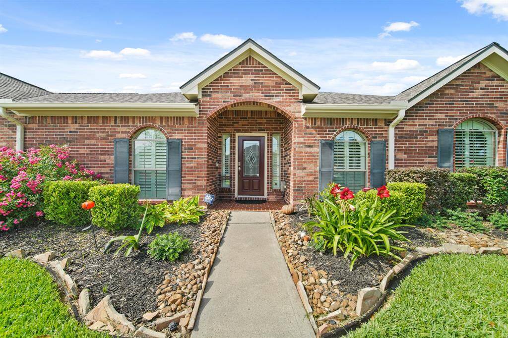 Inviting entryway with lush greenery and mature landscape