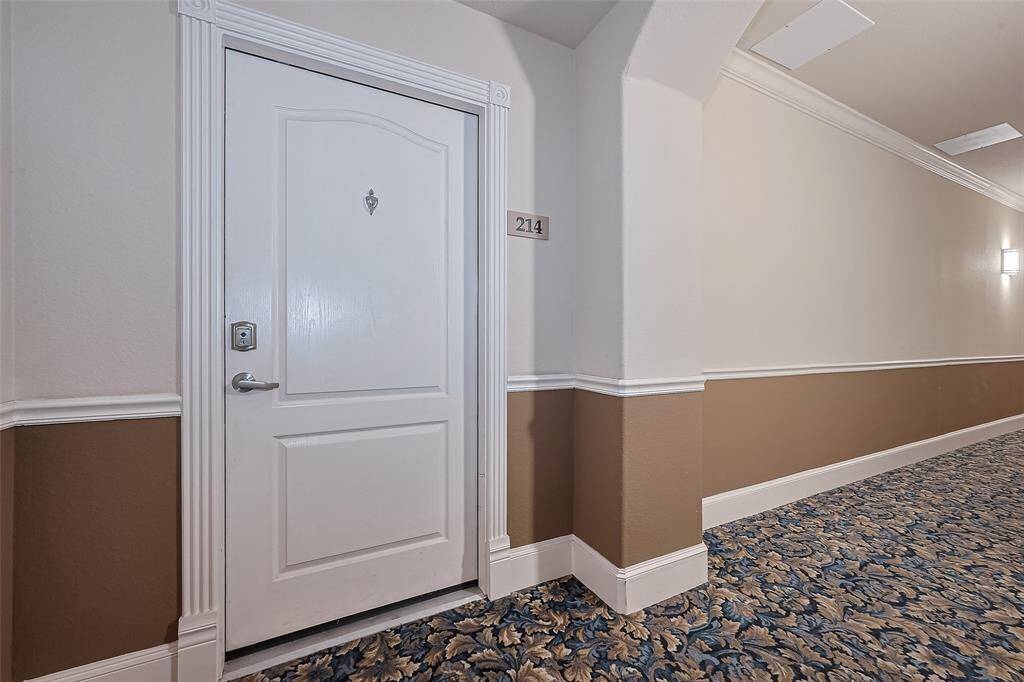 An inviting entrance, the front door opens from a graceful hallway that sets the tone with its understated elegance.
