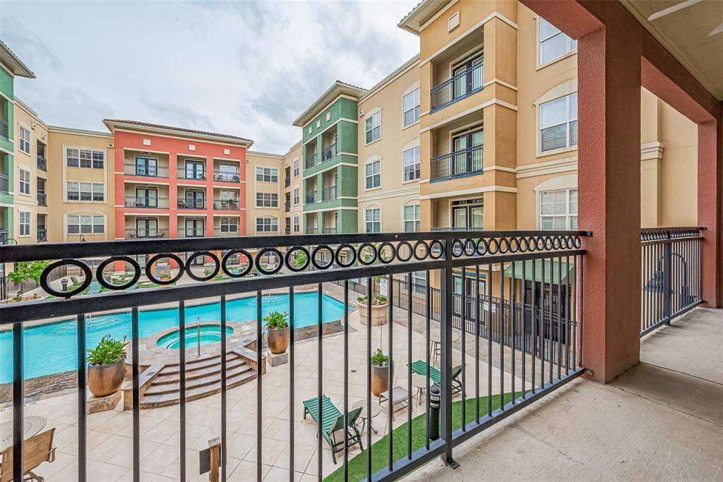 From the balcony, enjoy serene views of the sparkling pool below and the surrounding community architecture—a tranquil scene just outside your door.