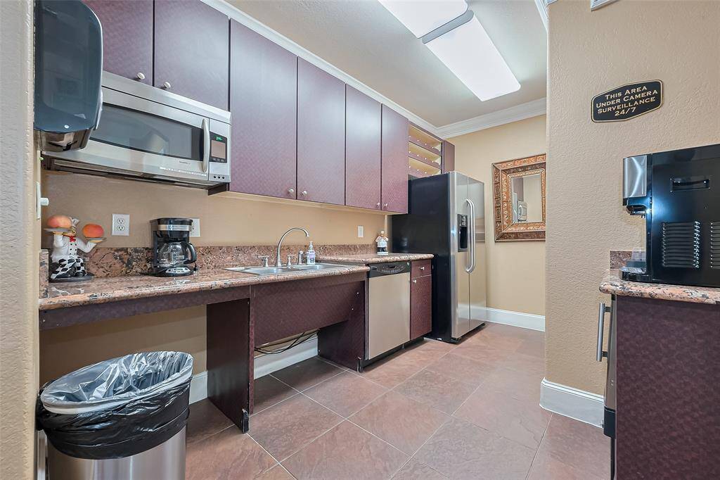 The clubroom’s kitchenette offers convenience with appliances, counter space and cabinetry—ideal for events and entertaining.