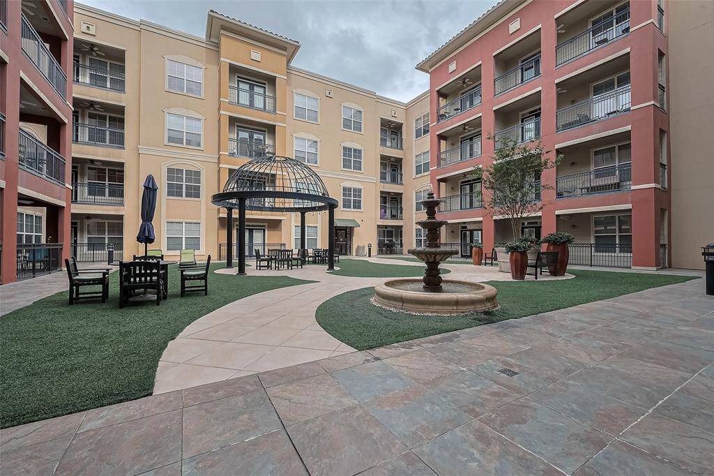 The peaceful courtyard features inviting seating areas, a charming gazebo, and a calming fountain—perfect for unwinding or socializing outdoors.