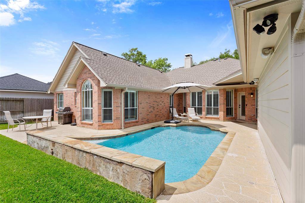 Step around the corner to see that the patio and pool deck is extended for grilling and dining. The backyard area is wired for sound and has motion detection lighting.