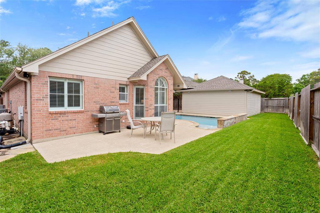 This charming backyard is enclosed by a "good neighbor" wooden fence, offering privacy and a well-maintained lawn. Perfect for relaxing and entertaining.