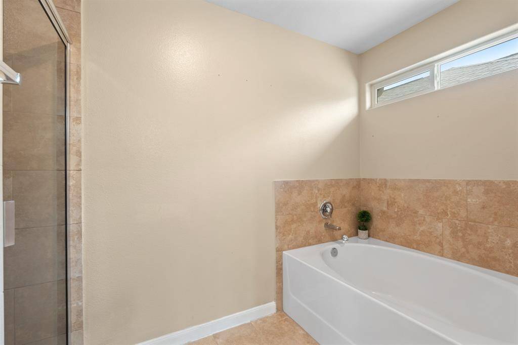 Garden tub and standing shower in primary bedroom