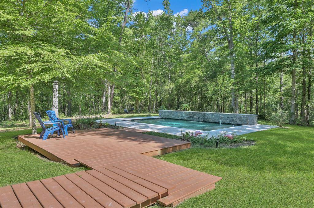 Terraced decking to pool area w/ sun deck and water features