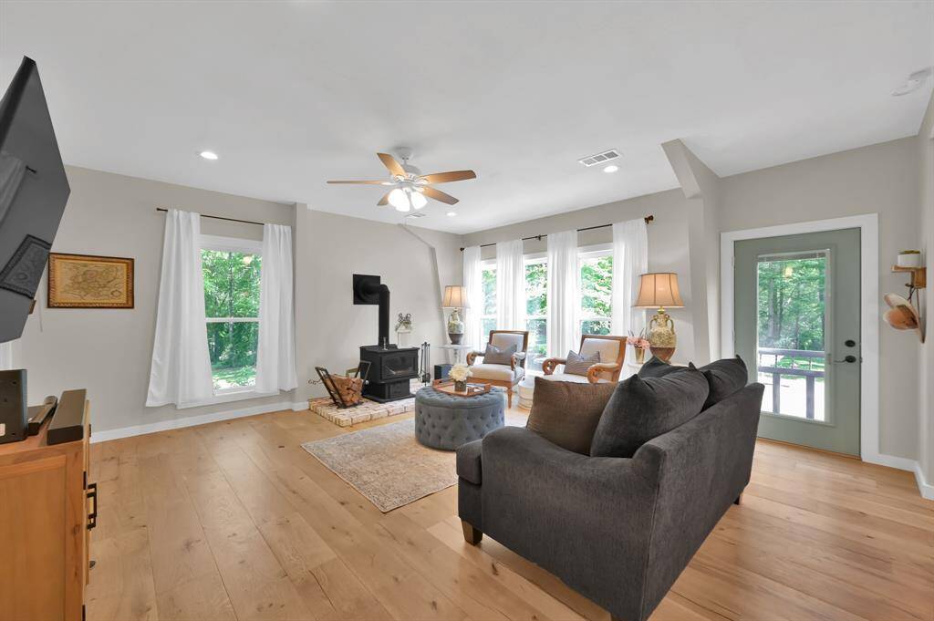 Natural light immerses the space. Cozy up to wood burning fireplace