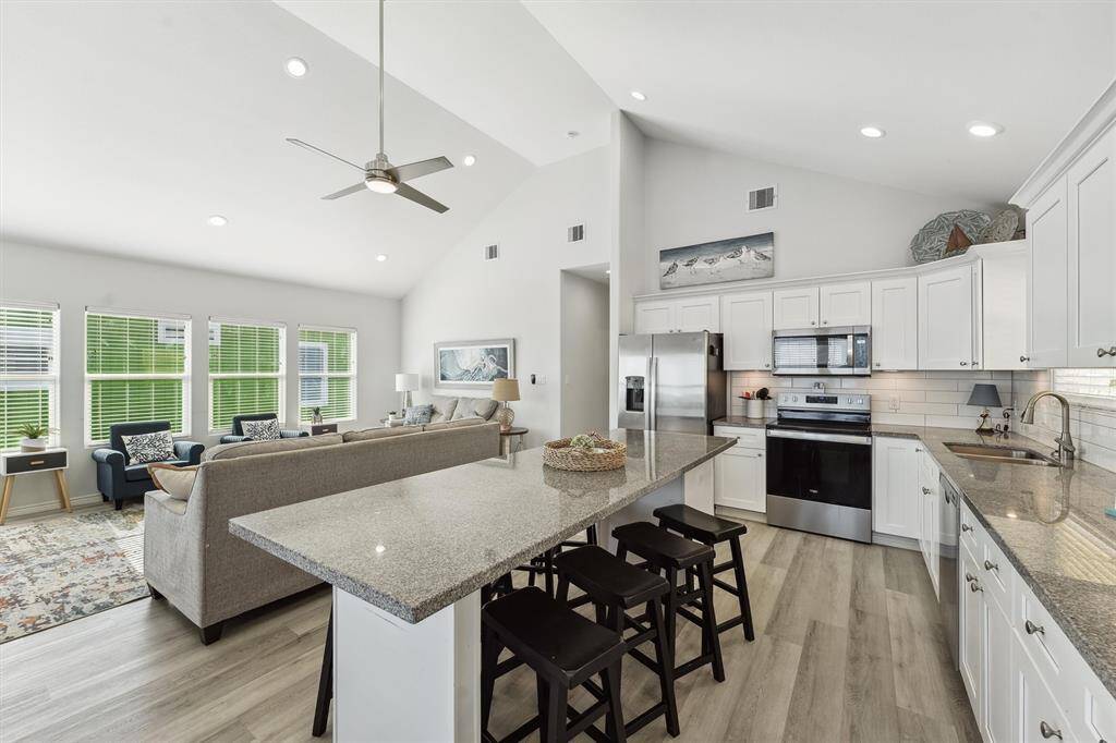 Bathed in natural light, this kitchen is equal parts functional and stylish with stainless steel appliances and coastal-inspired accents.