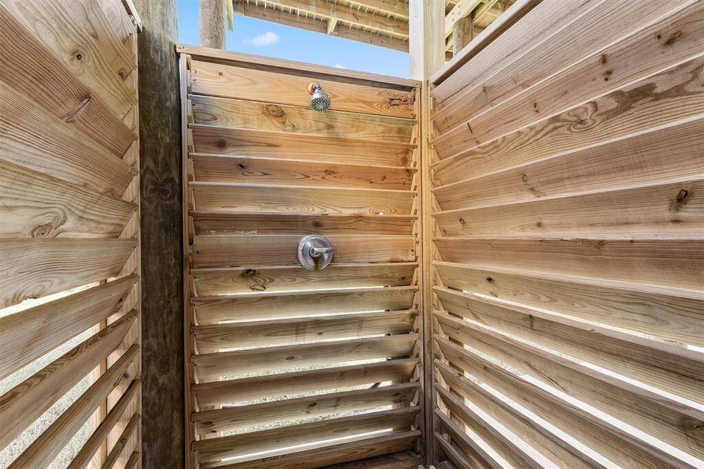 The spacious covered area beneath offers shaded parking and plenty of room for outdoor gatherings.