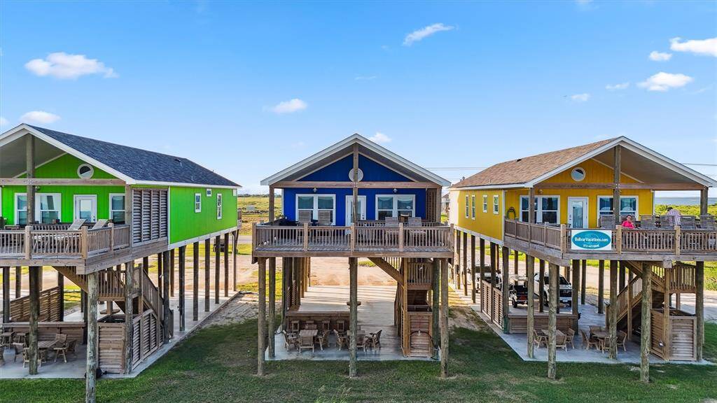 An aerial view showcases this row of homes perfectly perched on the beach, ready for your coastal escape.
