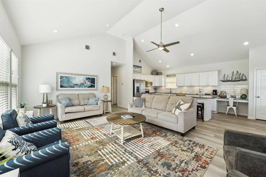 Coastal charm meets comfort in this airy living space with plenty of seating and relaxing beach-themed touches.