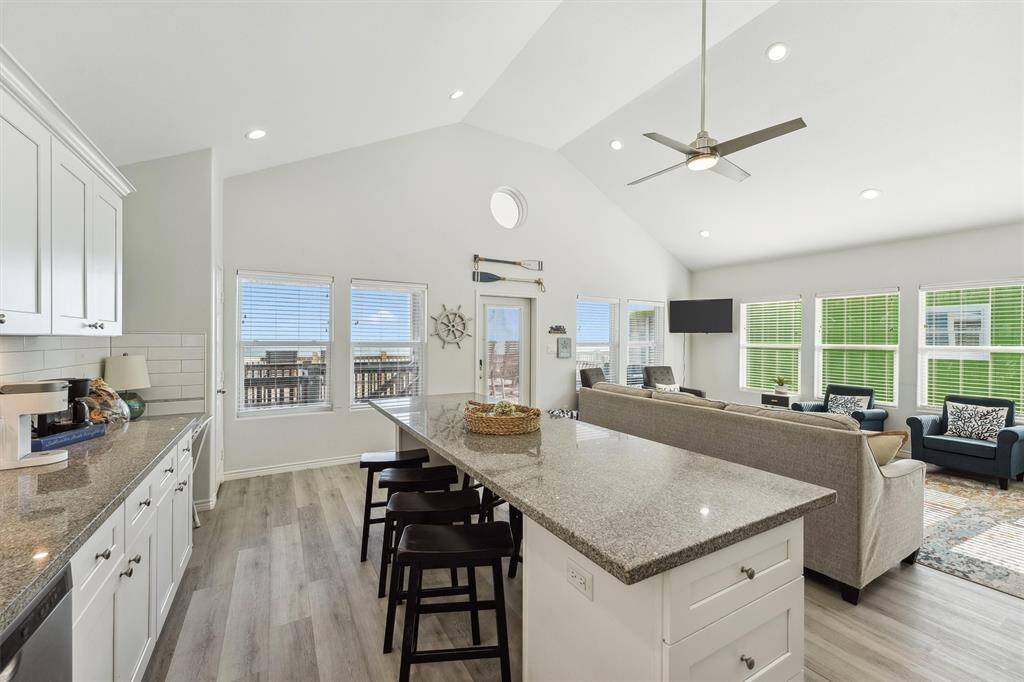 From the cozy seating area to the gleaming kitchen, this layout makes beach living feel effortless and fun.
