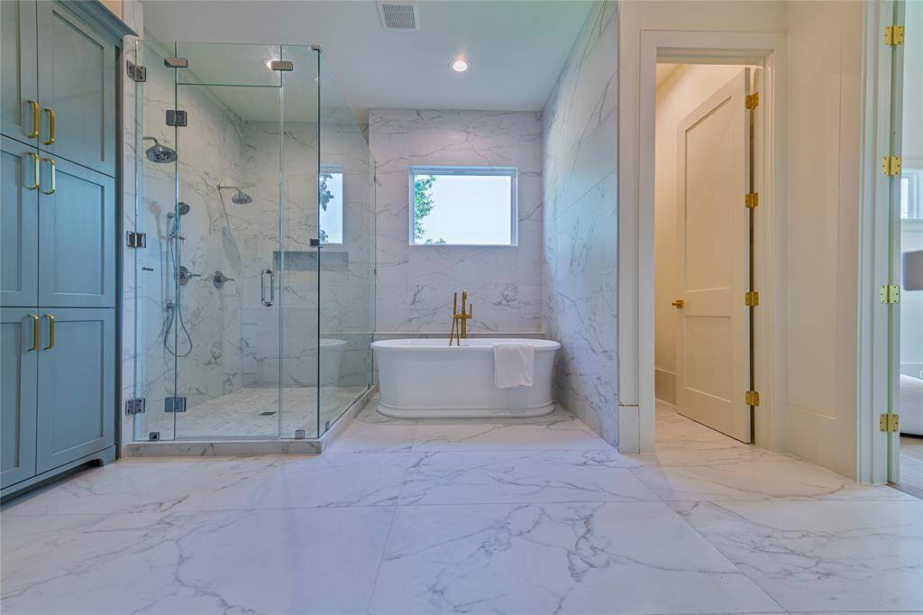 Exquisite soaking tub and frameless shower.