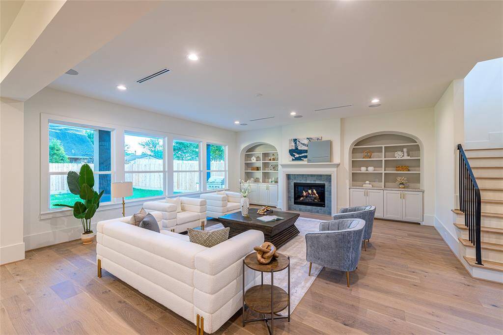 Beautiful fireplace and meticulously designed display cabinets add warmth to this luxurious space.