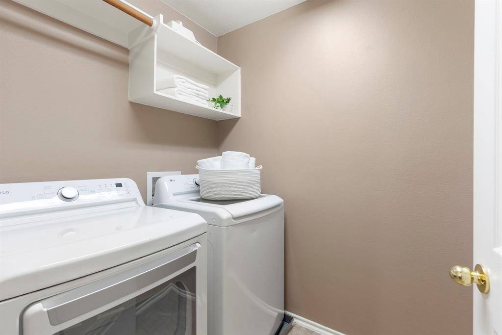 ice-sized laundry room with ample storage, offering both convenience and organization.