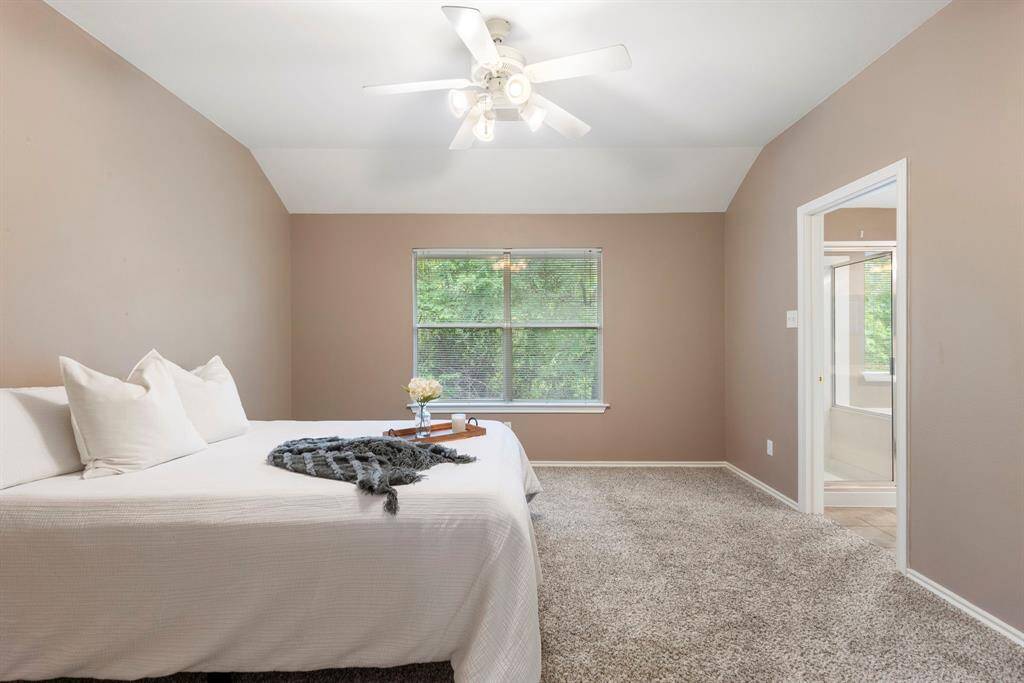 Spacious primary bedroom with a wonderful view of the trees, creating a peaceful and serene retreat.