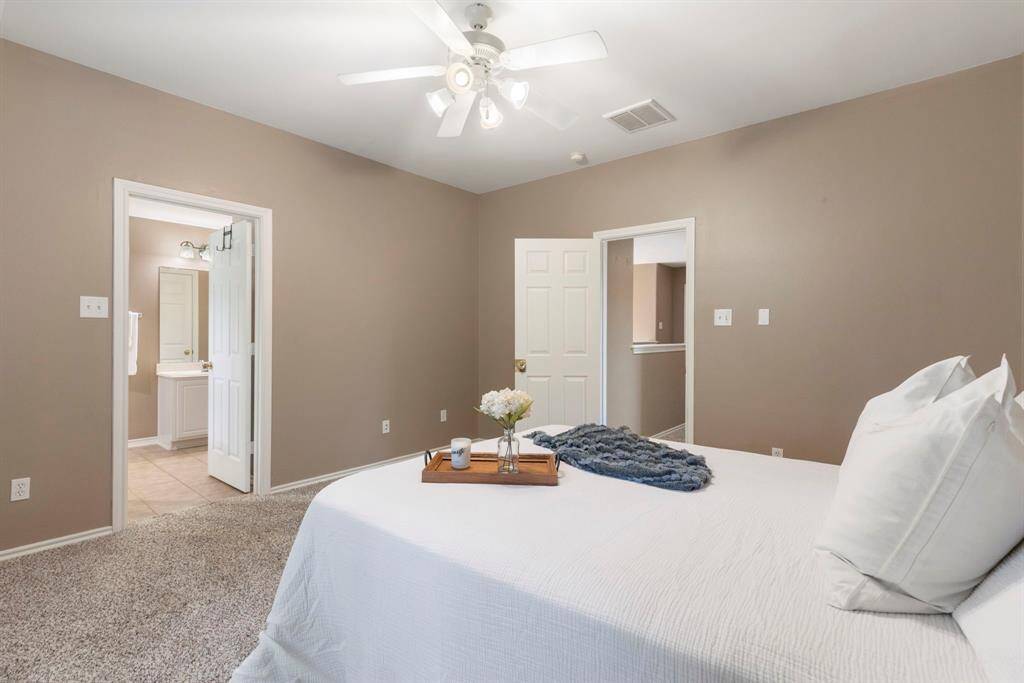 Another view of the primary suite, offering convenient access to the laundry room for added ease and functionality.