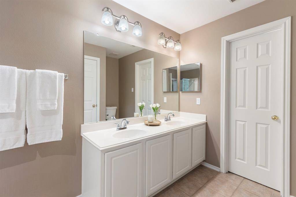 The double sinks in the primary bath make getting ready in the morning more convenient and efficient.