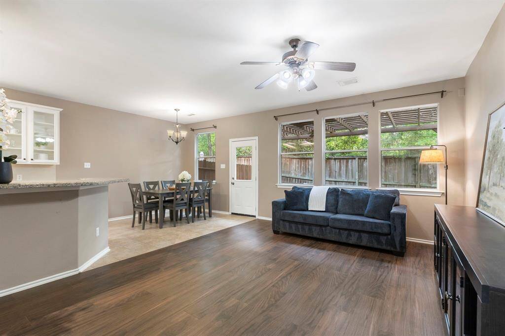 The open living space is light and airy, featuring stylish wood-look tile.