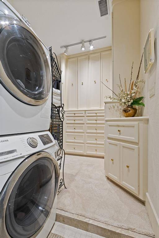 This convenient utility area, located just off the walk-in shower, is ready for your washer and dryer. It leads to a spacious dressing area, offering everything you need in one place.