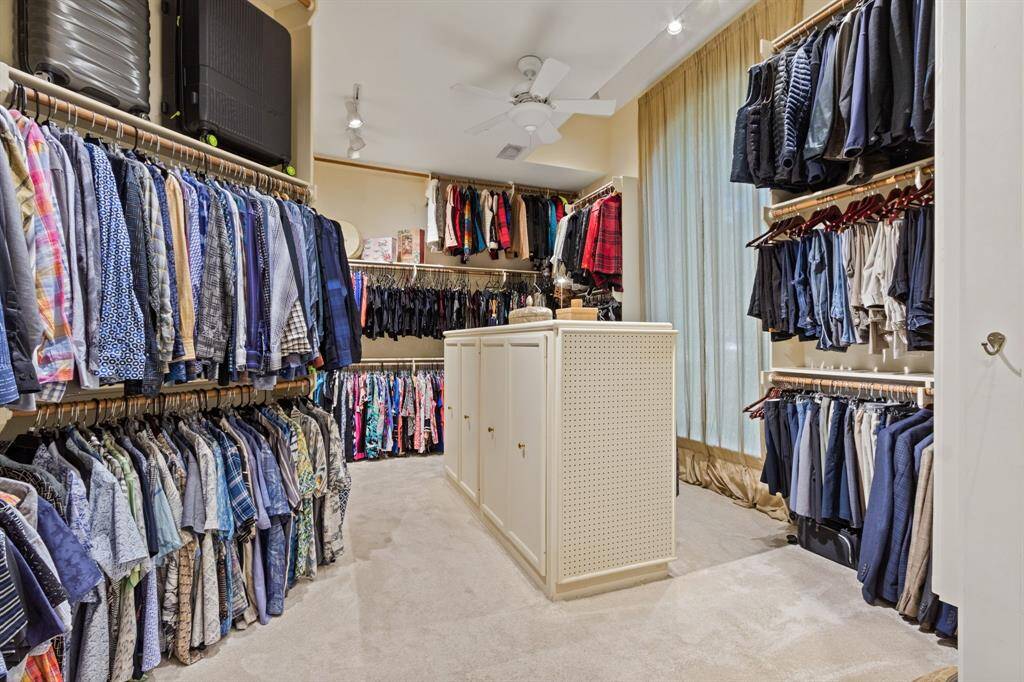 Discover the ultimate walk-in closet with over 100 linear feet of hanging space, 25 drawers, storage for 100+ pairs of shoes, and a convenient in-wall ironing station.  This picture doesn't begin to show you how huge this closet is!