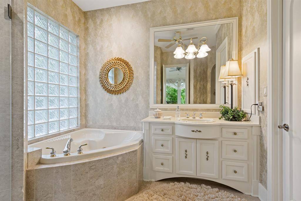 This elegant third suite features vaulted ceilings and soft lighting, creating a cozy and inviting atmosphere. Large windows allow natural light to fill the space, enhancing its serene appeal. This room is perfect for guests with its own private entrance off the driveway and bath.