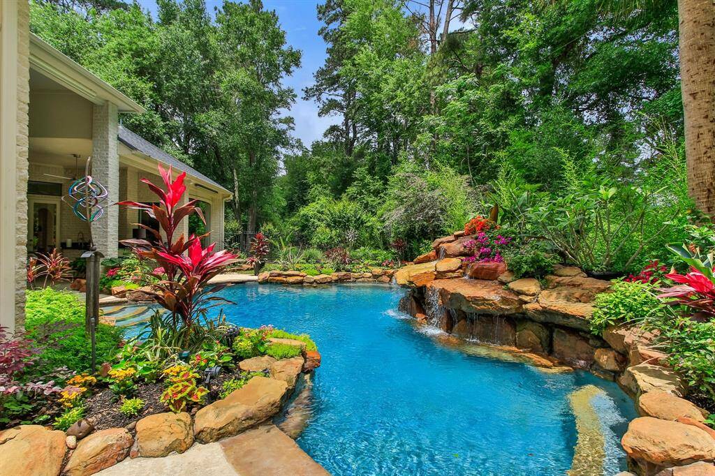 Absolutely stunning backyard, professional landscaping, tropical pool, and privacy!!