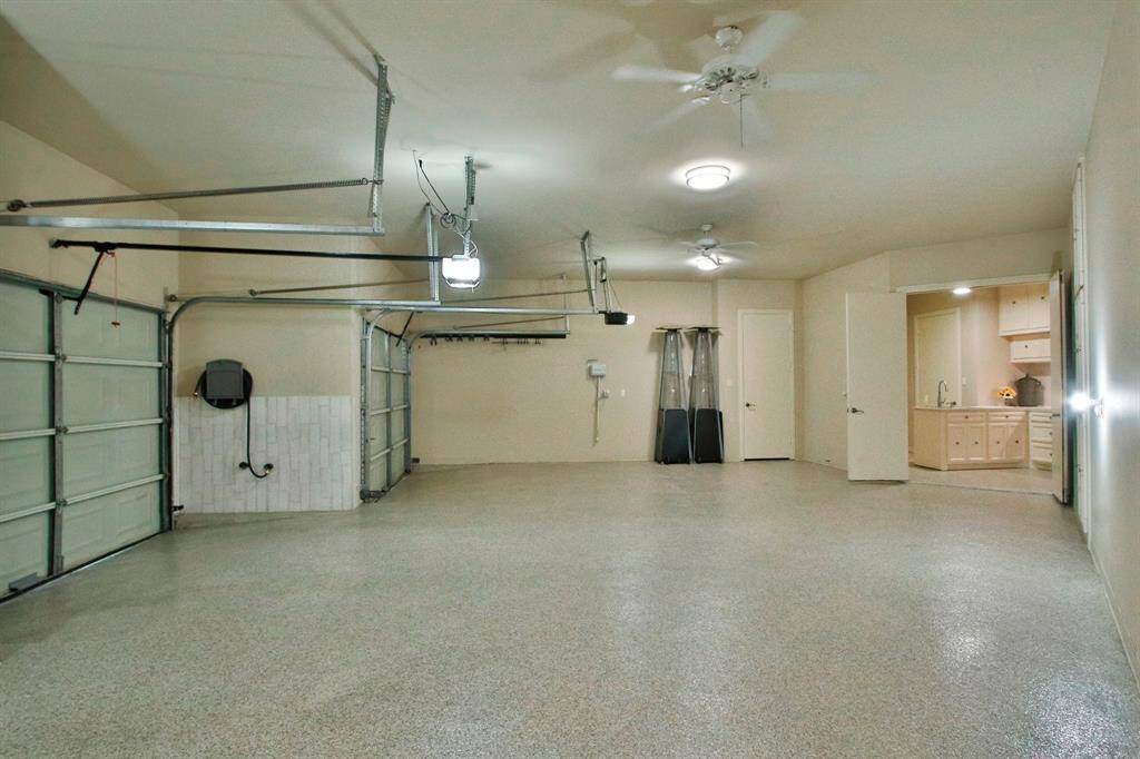 This spacious, well-lit 3 car garage features ceiling fans, and epoxy for that nice and clean look.