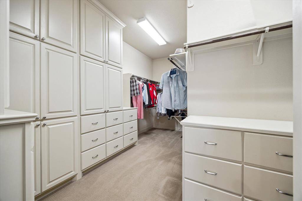 Huge walk-in closet boasts built-ins and abundant hanging space.