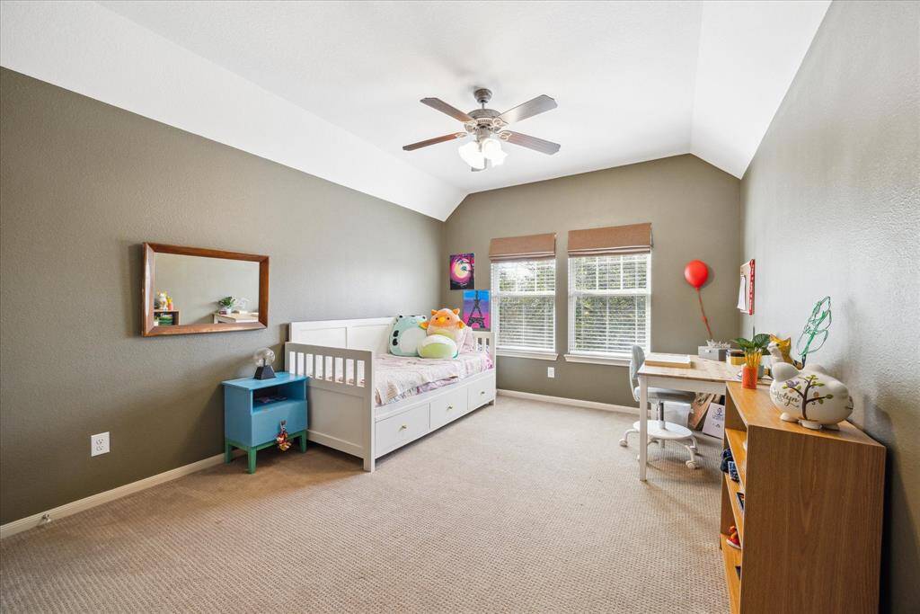 Another spacious guest bedroom with windows overlooking the treetops.