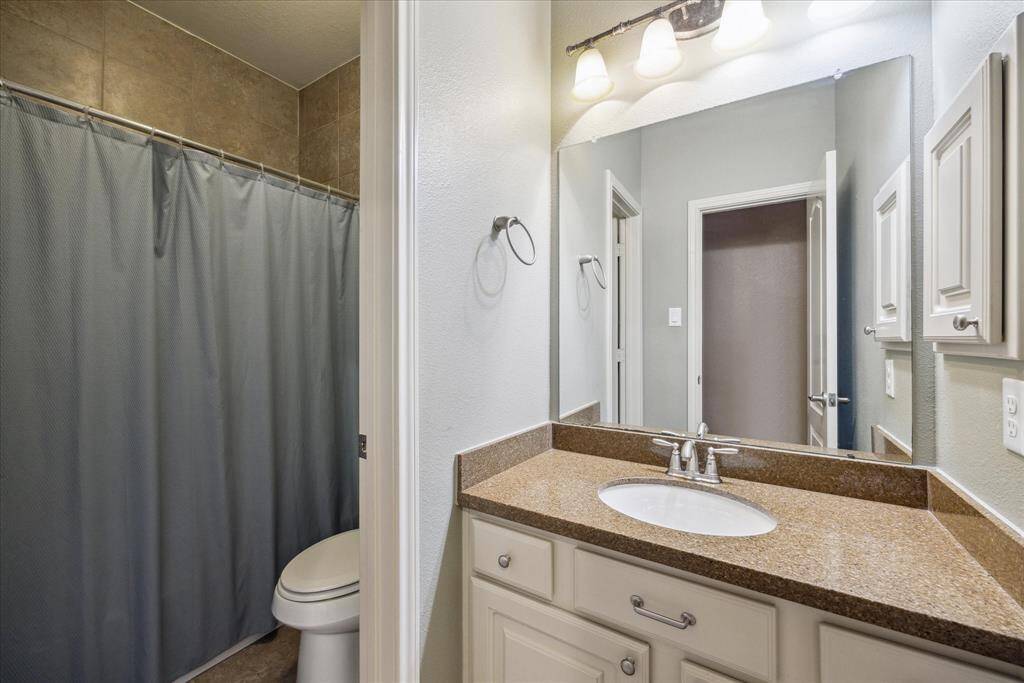 Guest bath with tub/shower combo serves one of the guest bedrooms.