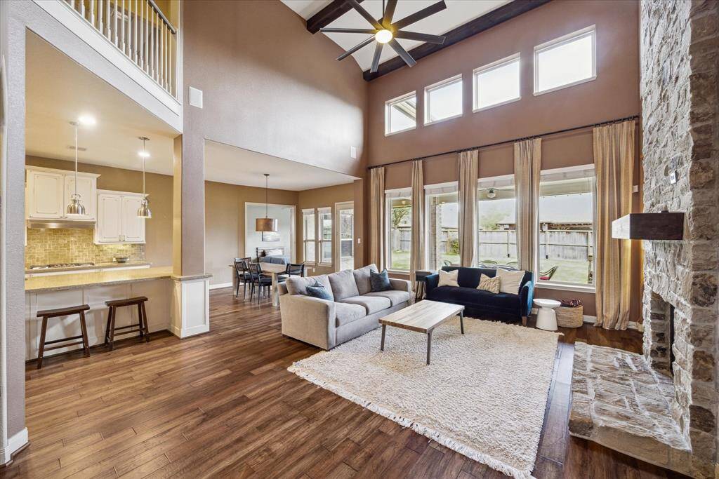 Family room is the heart of the home. Appreciate the incredible high ceilings, abundant natural light, and a seamless flow to the kitchen and breakfast room.