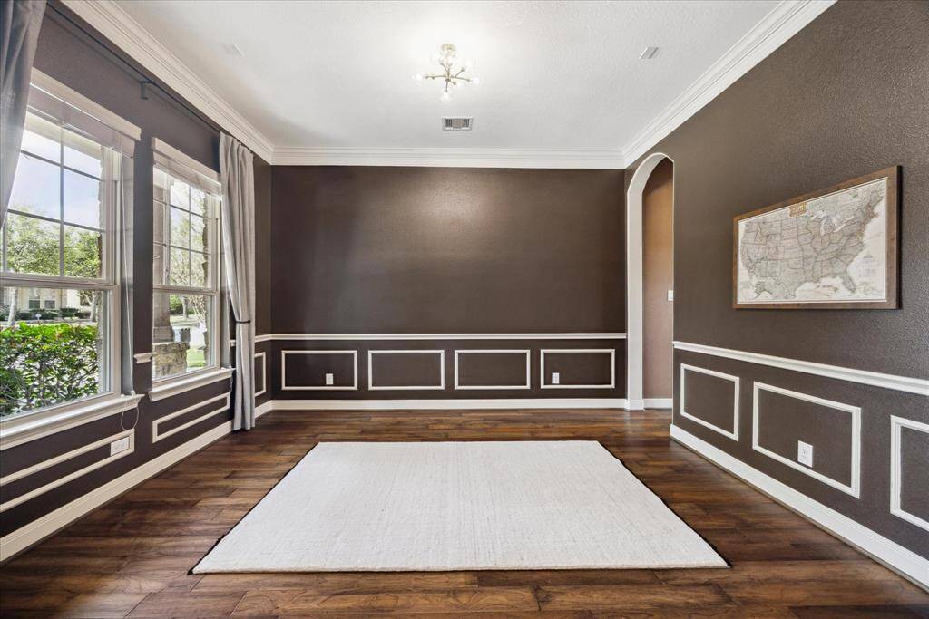 Formal dining room is just off the foyer and features classic chair rail and wainscoting.