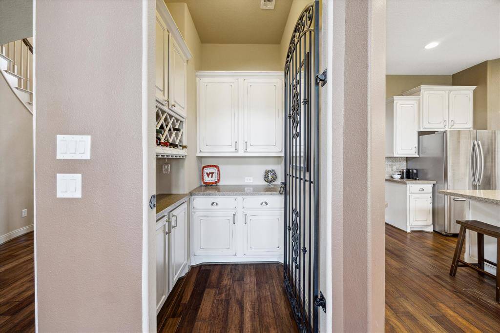 Wine room between iron door is great for entertaining or additional storage.