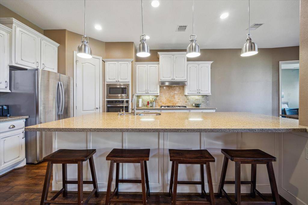 Another perspective of the chef's island kitchen, complete with all of your culinary needs!