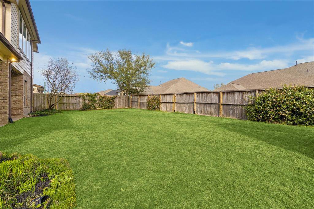 Super private backyard offers endless green space, butterfly garden, and plenty of room for a pool!