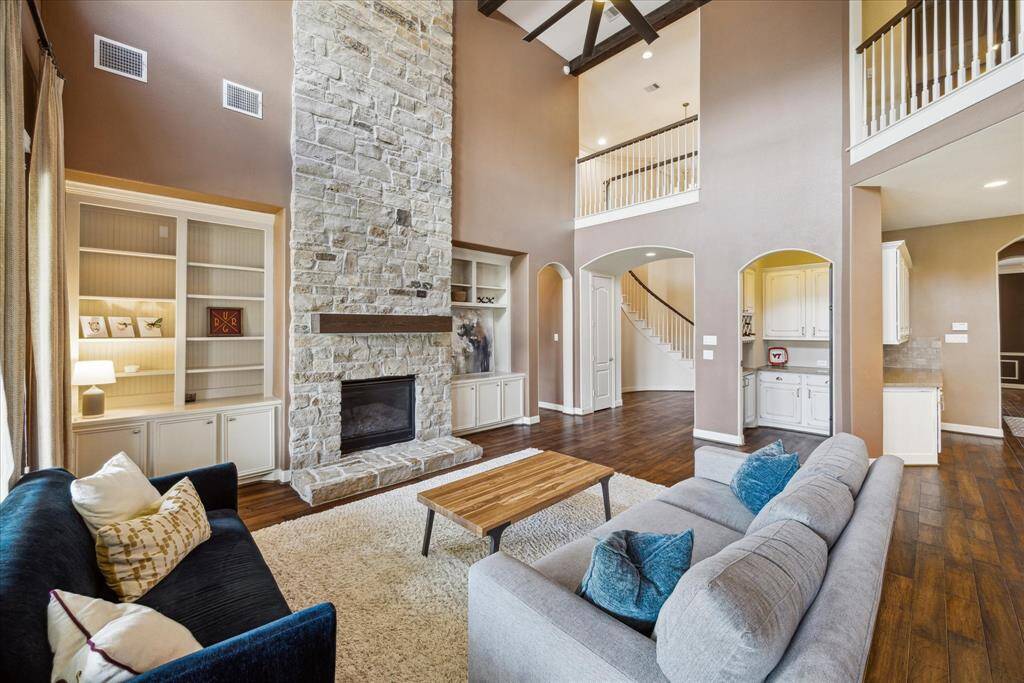 Another view of the family room showing the stone fireplace and engineered hardwoods which continue throughout most of the first floor.