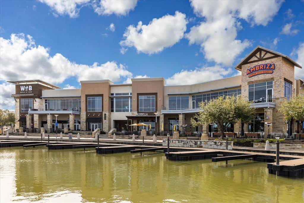 View of the lake and boat dock which allows residents enjoyable access to shopping, dining, entertainment options.