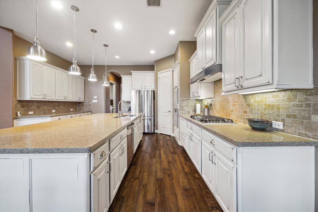 Another view of the island kitchen showing the endless prep and storage options plus under cabinet lighting.