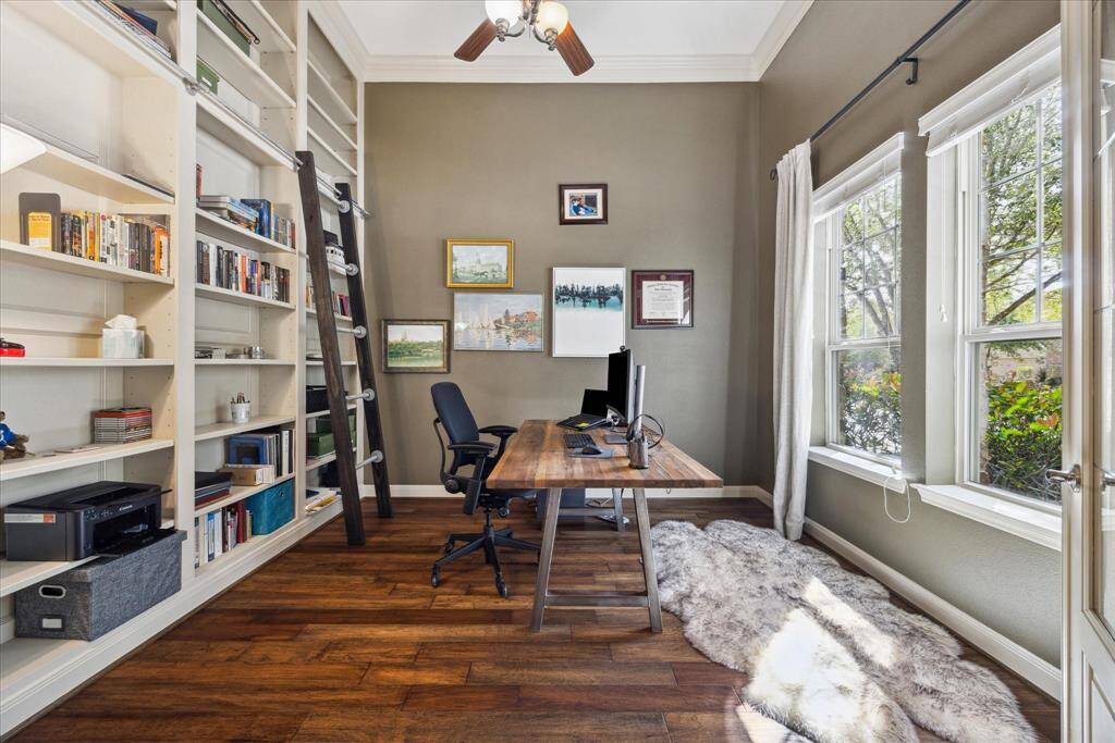 Formal study through French doors is just off the entry. Note the built-in shelves and library ladder.