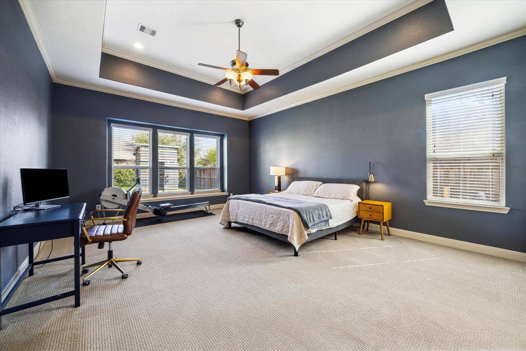 First floor primary suite is incredibly spacious. High ceilings with tray accent enhance the size of this room.