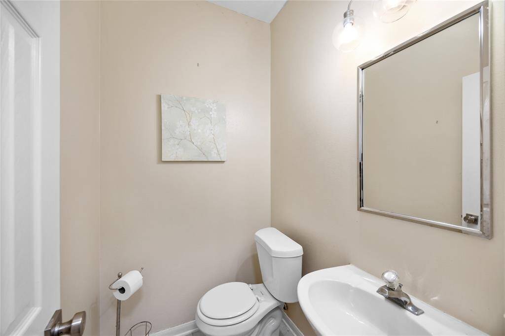 Also just past the stairway is a half bathroom! Super conventient for you and your guests!