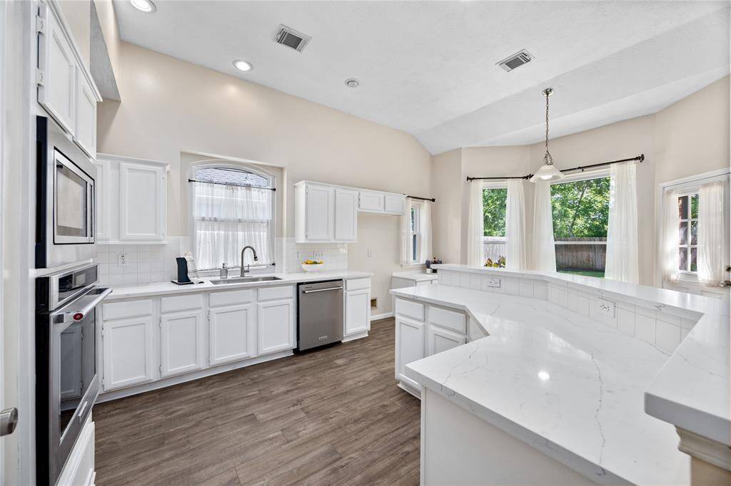 Walk past the two formal rooms into this nicely updated kitchen! Brand New Granite Countertops, re-finished cabinets and fresh neutral paint really open up this Kitchen!