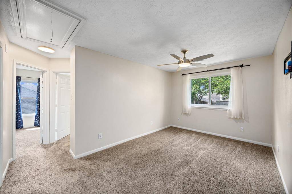 Gameroom upstairs is situated between the two secondary bedrooms and the large primary bedroom.