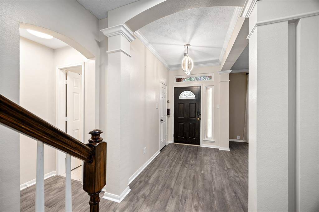 Entryway shows off the brand new floors, neutral paint throughout the home, and welcoming foyer.